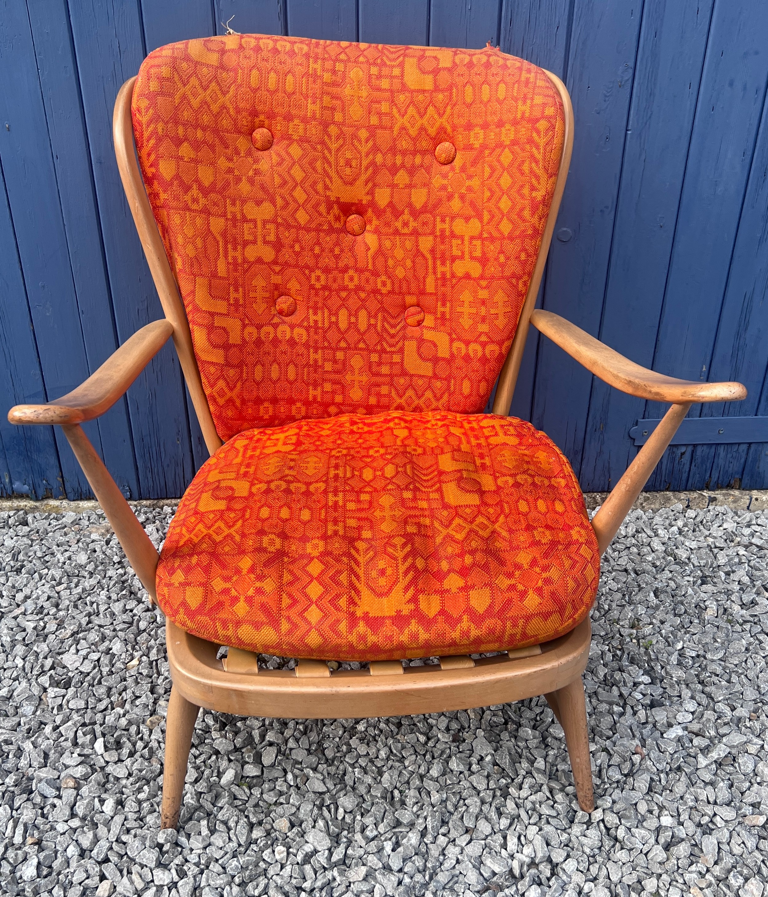 A large Ercol blonde armchair with blue label. 62cm w x 84cm h.