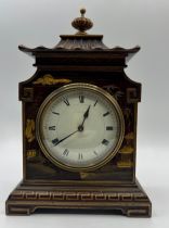 A early 20thC chinoiserie style, wooden cased mantle clock with Pagoda temple shape, French movement
