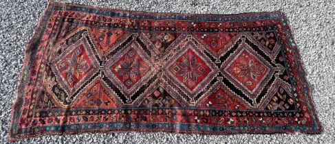 An orange and blue ground wool rug. 278cm x 131cm.