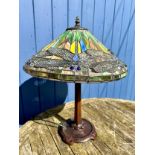 A Tiffany style table lamp with dragonfly decoration and a heavy metal base. Ht to top of shade