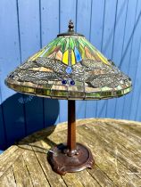 A Tiffany style table lamp with dragonfly decoration and a heavy metal base. Ht to top of shade