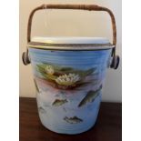 A Winton Grimwades transfer printed slop bucket with fish and waterlily design with wicker handle.