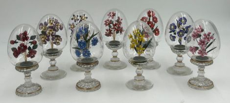 Nine Franklin Mint House of Fabergé clear glass pedestal eggs, each with an enamel floral spray with