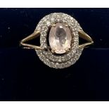 A 9 carat gold ring set with pink and clear stones. Size P. Weight 2.6gm.