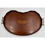 An Edwardian Mahogany kidney shaped tray with brass handles and shell inlay to centre. 45cm x 28cm.
