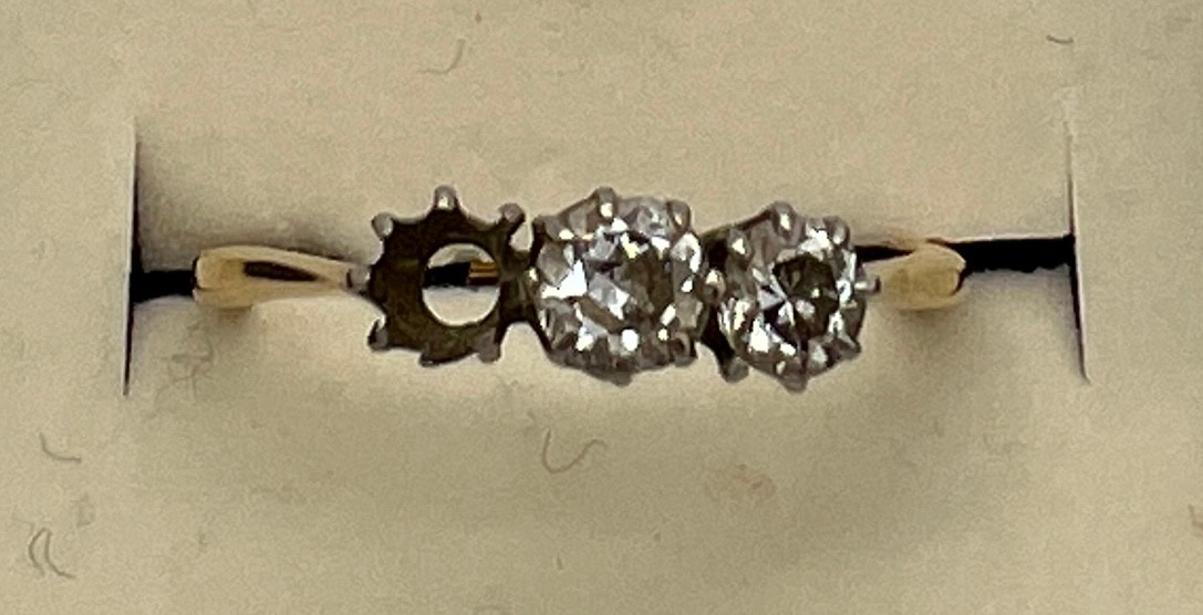 An 18 carat gold diamond set ring. One stone missing. Size P. Weight 1.9gm.