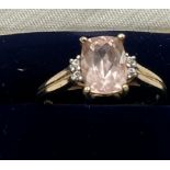 A 9 carat gold ring set with pink and clear stones.. Size P. Weight 2.4gm.