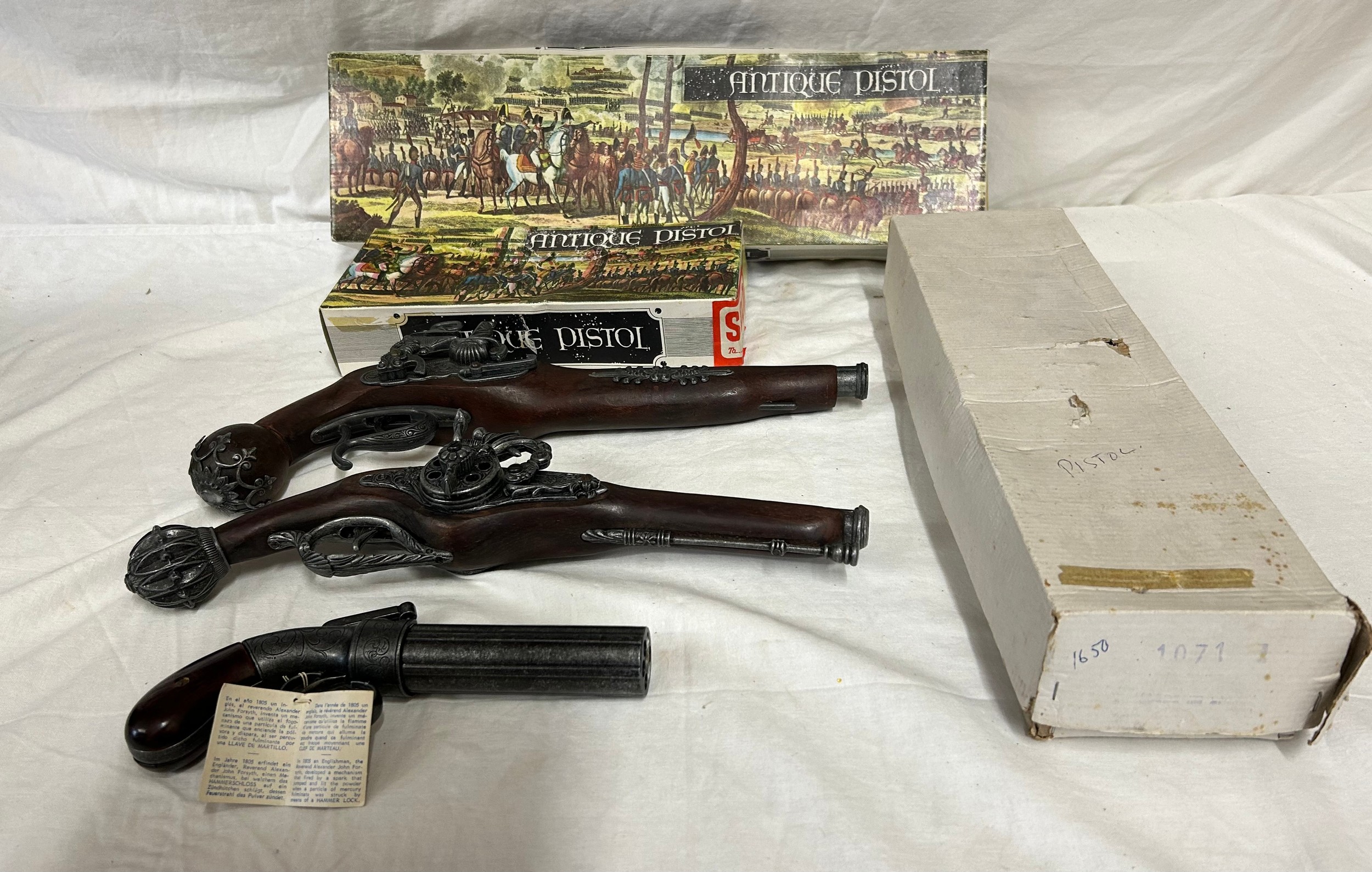 Three boxed antique pistol replicas, made in Spain.