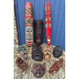 Ten tribal wall hanging masks to include 3 painted. Tallest two 100cm l & 103cm l.