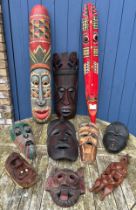 Ten tribal wall hanging masks to include 3 painted. Tallest two 100cm l & 103cm l.