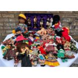 A quantity of mainly foreign/ tourist dolls to include knitted, wooden and plastic, some hand