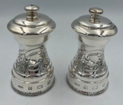 A boxed hallmarked silver salt and pepper grinder. Grinder marked Peugeot to mechanism. Birmingham