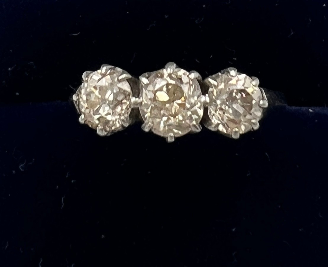 A three stone diamond ring mounted in platinum. Size K. Weight 3.5gm. Approximate diamond