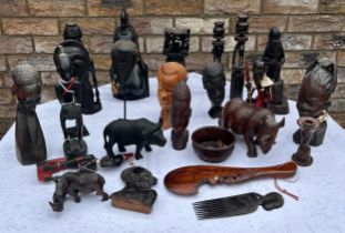 Tribal figures, ornaments, candlestick holders, rhinos, heavy bust of a tribal woman 34cm h and a