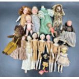 A collection of small dolls to include seven folk art style wooden peg dolls, 15cm l, six with