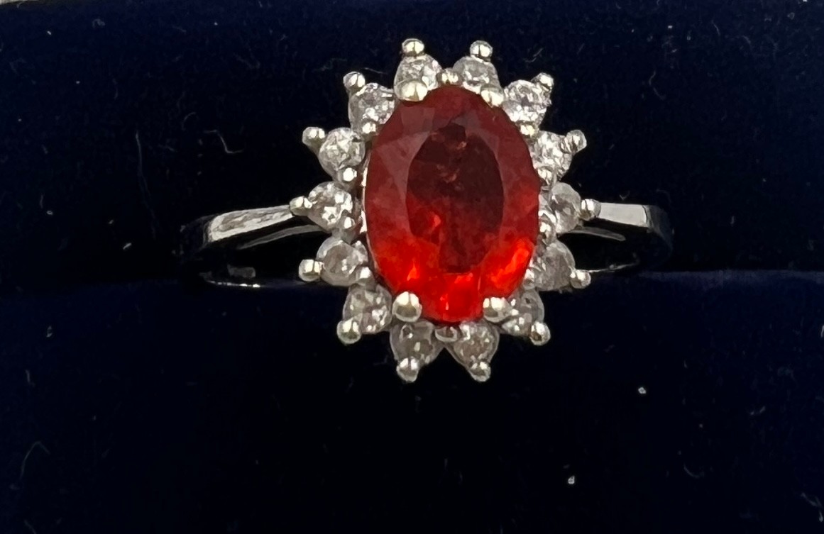 A 9 carat gold ring set with orange and clear stones. Size N. Weight 2.3gm.