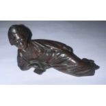 An oriental bronze figure of a reclined woman reading a book. Marks to underneath. 11cm w.