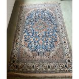 Hand knotted silk Persian rug. 190cm l x 119cm w.