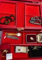 A vintage jewellery box and contents to include silver chain bracelet, silver pendant, gold plated