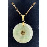Circular green stone pendant on 9 carat yellow gold chain. Chain 62cm l. Total weight 7.1gm.