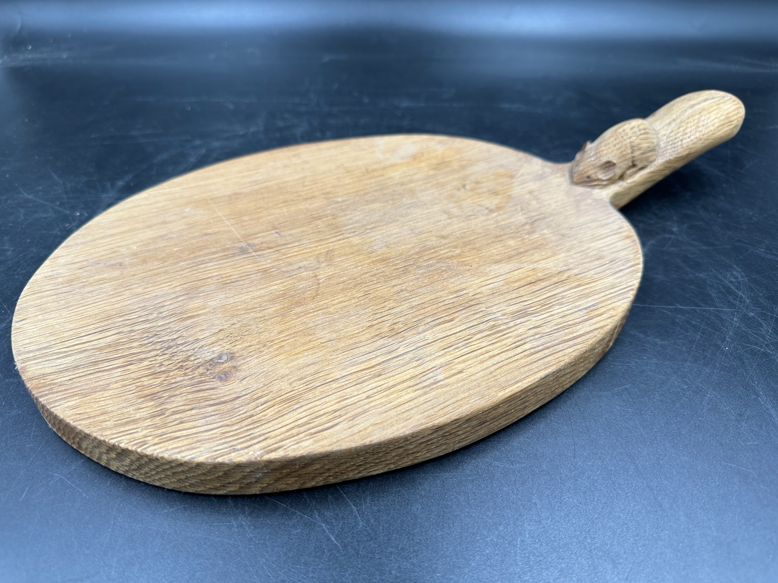 Robert Thompson 'Mouseman' of Kilburn, an adzed oak cheese board of oval form with a carved mouse - Image 3 of 5