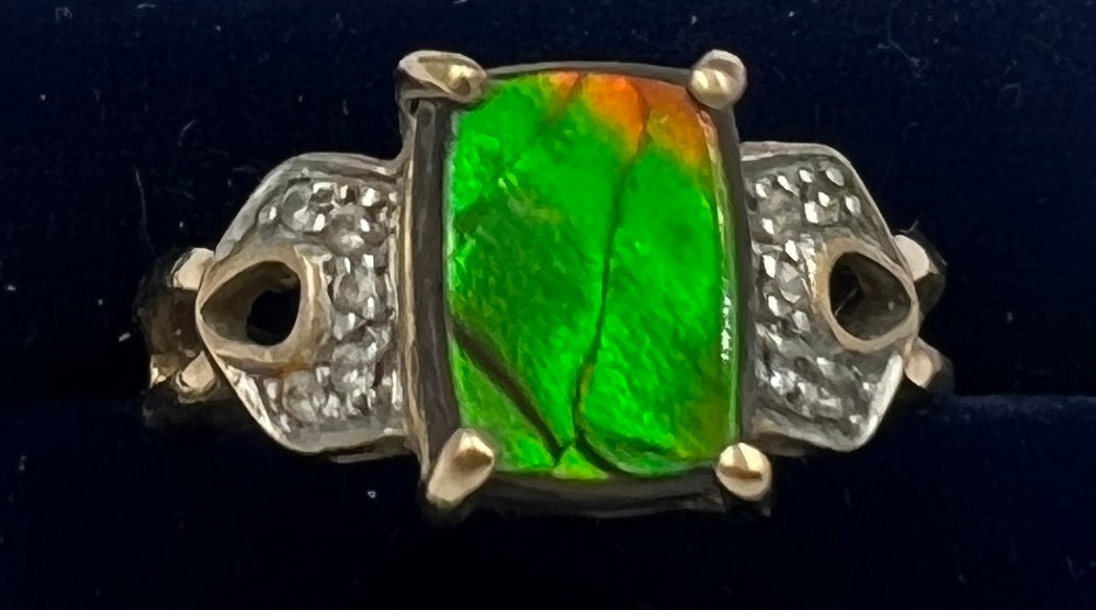 A 9 carat gold ring set with green and clear stones. Size O/P. Weight 4.3gm.