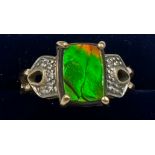 A 9 carat gold ring set with green and clear stones. Size O/P. Weight 4.3gm.