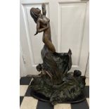 A large heavy, metal sculpture of mermaids amidst the waves. Height approx. 80cm, base width 60cm.