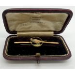 A 9 carat gold pheasant bar brooch in fitted silk and velvet lined leather case. 5.3cm l. Weight 1.