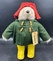 A Gabrielle designs vintage Paddington Bear with dark green duffel coat and yellow Dunlop