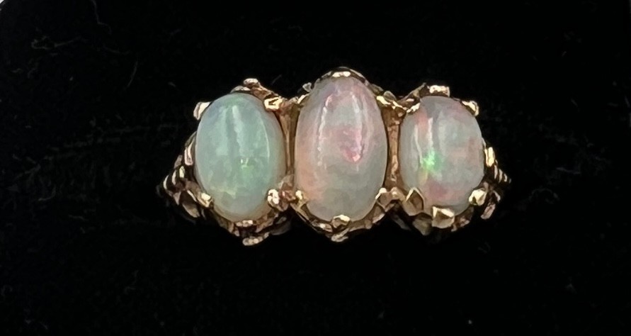 A nine carat gold ring set with three opals. Size J/K. Weight 3.7gm. - Image 2 of 3