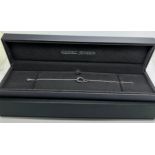 A boxed Georg Jensen Offspring .925 silver and .750 gold bracelet in original presentation box.