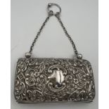 A hallmarked silver purse with chain and finger ring with repoussé decoration and vacant