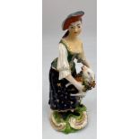 An 18thC figure of a shepherdess, 13.5cm h. Marked N 40 to base.