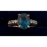 A 9 carat gold ring set with blue and clear stones. Size P. Weight 2.1gm.