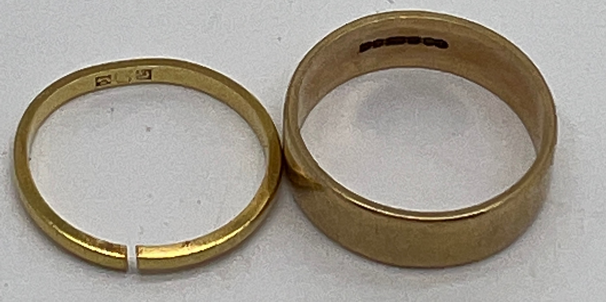 Two gold wedding bands, one 9 carat gold 3.1gm, the other 18 carat 1.6gm.