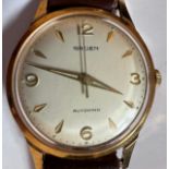 A vintage 1960's automatic Gruen Autowind with luminous dial and gold plated bezel, sweeping