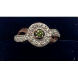 A 9 carat gold ring set with green and clear stones. Size O. Weight 3.4gm.