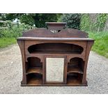 An oak shelf unit with central mirrored door. 83 w x 22 d x 73cm h.