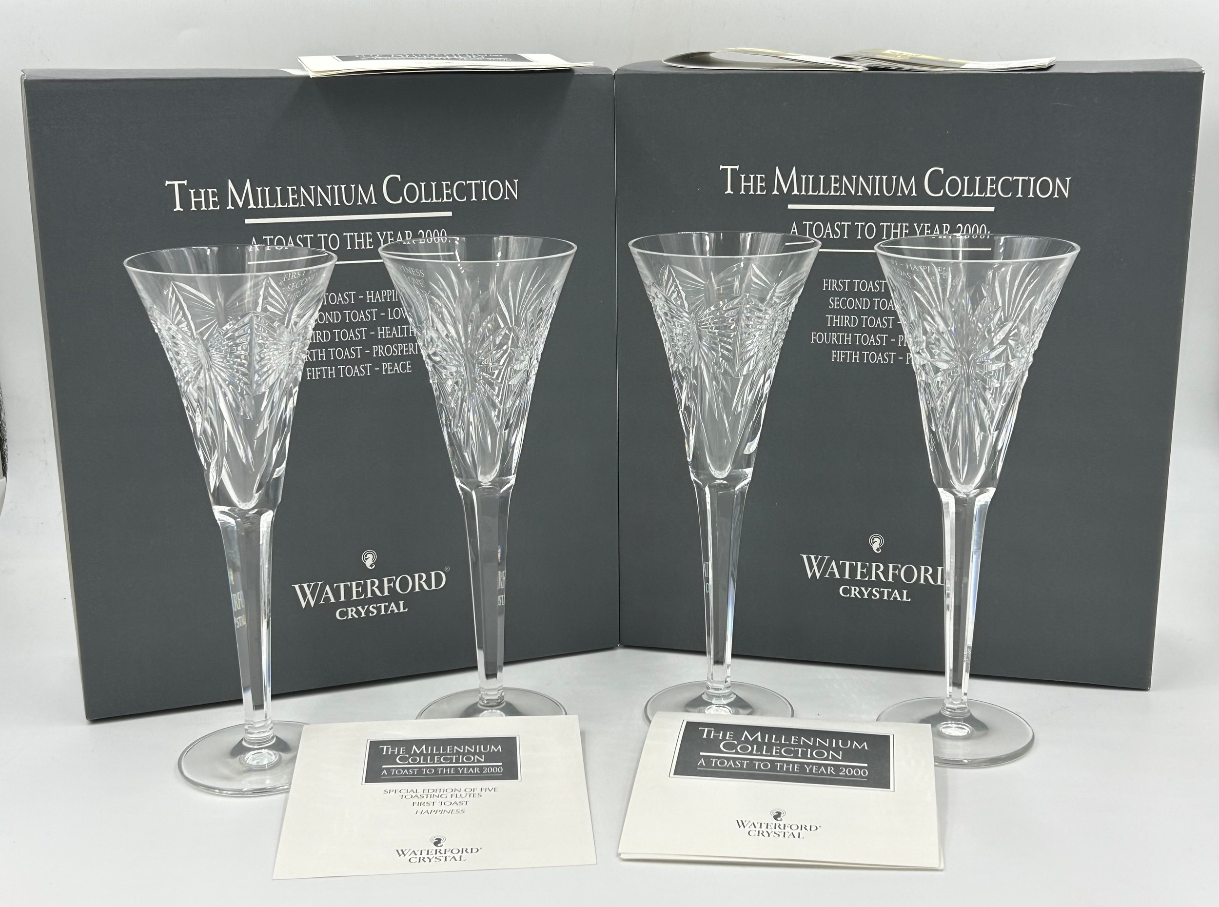 Two boxed pairs of Waterford crystal champagne flutes from 'The Millennium 2000 Collection', 23.