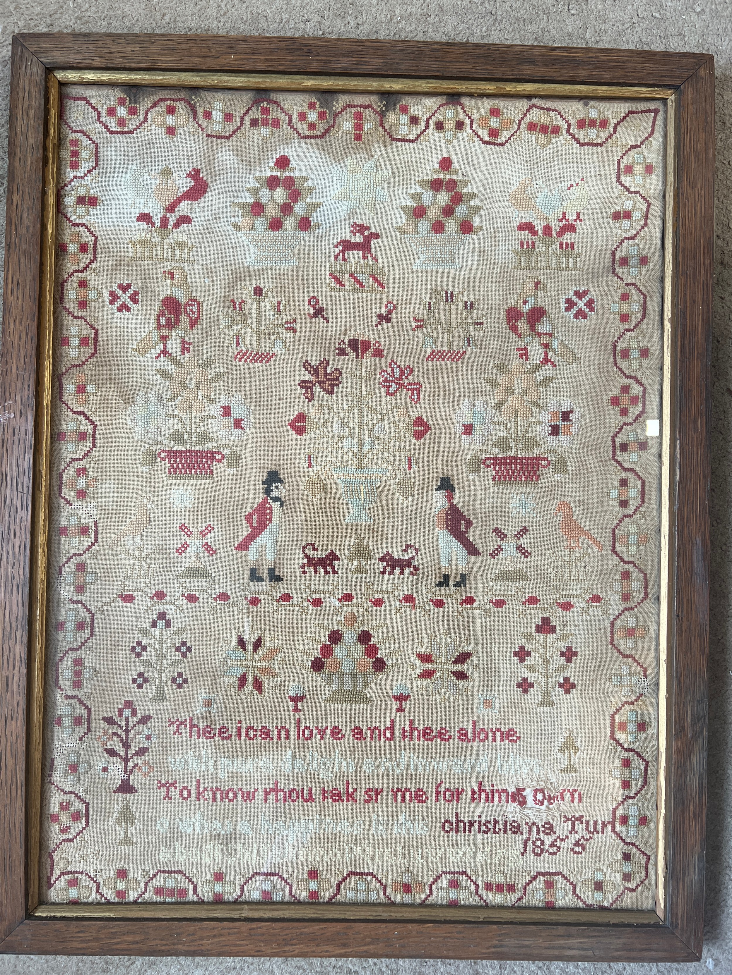 A wool cross stitch sampler by Christiana Tur 1855. 59cm x 46cm.