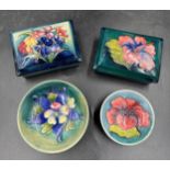 A collection of four pieces of Moorcroft pottery two oblong boxes with covers approx 9cm x 11.5cm