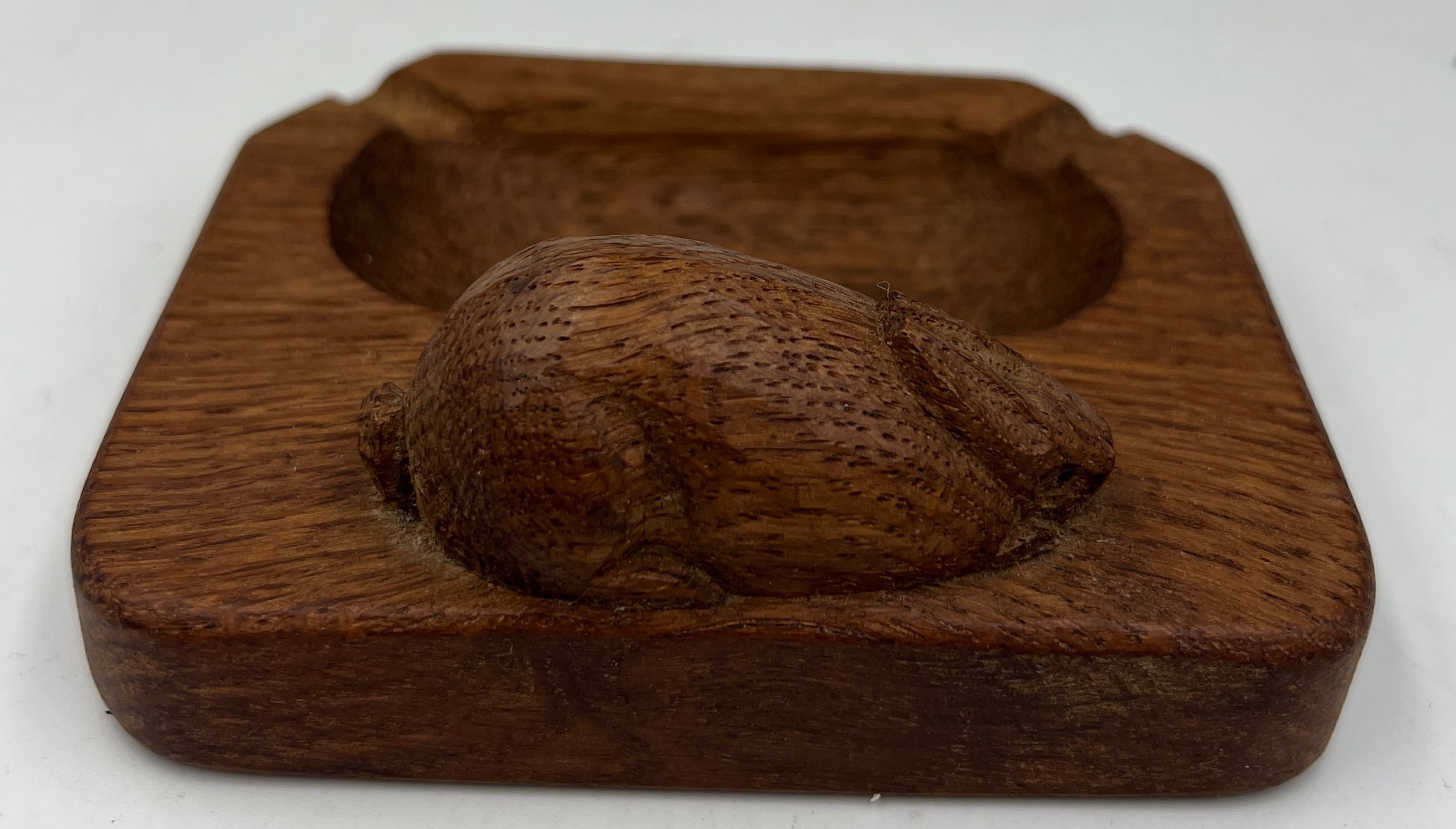 A Peter Heap ‘Rabbitman’ oak ashtray. 10cm x 8.5cm. Marked to underside N with tree. - Image 2 of 4