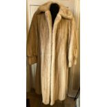 A long pale mink fur coat with label for Konrad Furs Sloane Street London.
