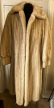 A long pale mink fur coat with label for Konrad Furs Sloane Street London.