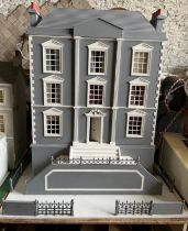 A large modern dolls house and extensive contents. 112cm h x 98cm w x 78 d.