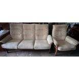 An Ercol teak three seater upholstered sofa and single armchair.