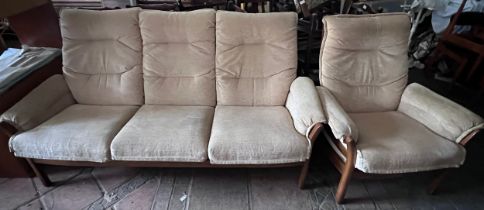 An Ercol teak three seater upholstered sofa and single armchair.