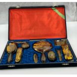 A Faux tortoiseshell 20thC vanity set with gold engraved dragon decoration in original silk lined
