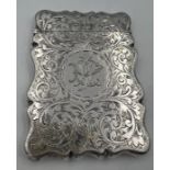A silver card case with foliage scroll engraving and initials to front. 9cm x 6.5cm. Birmingham